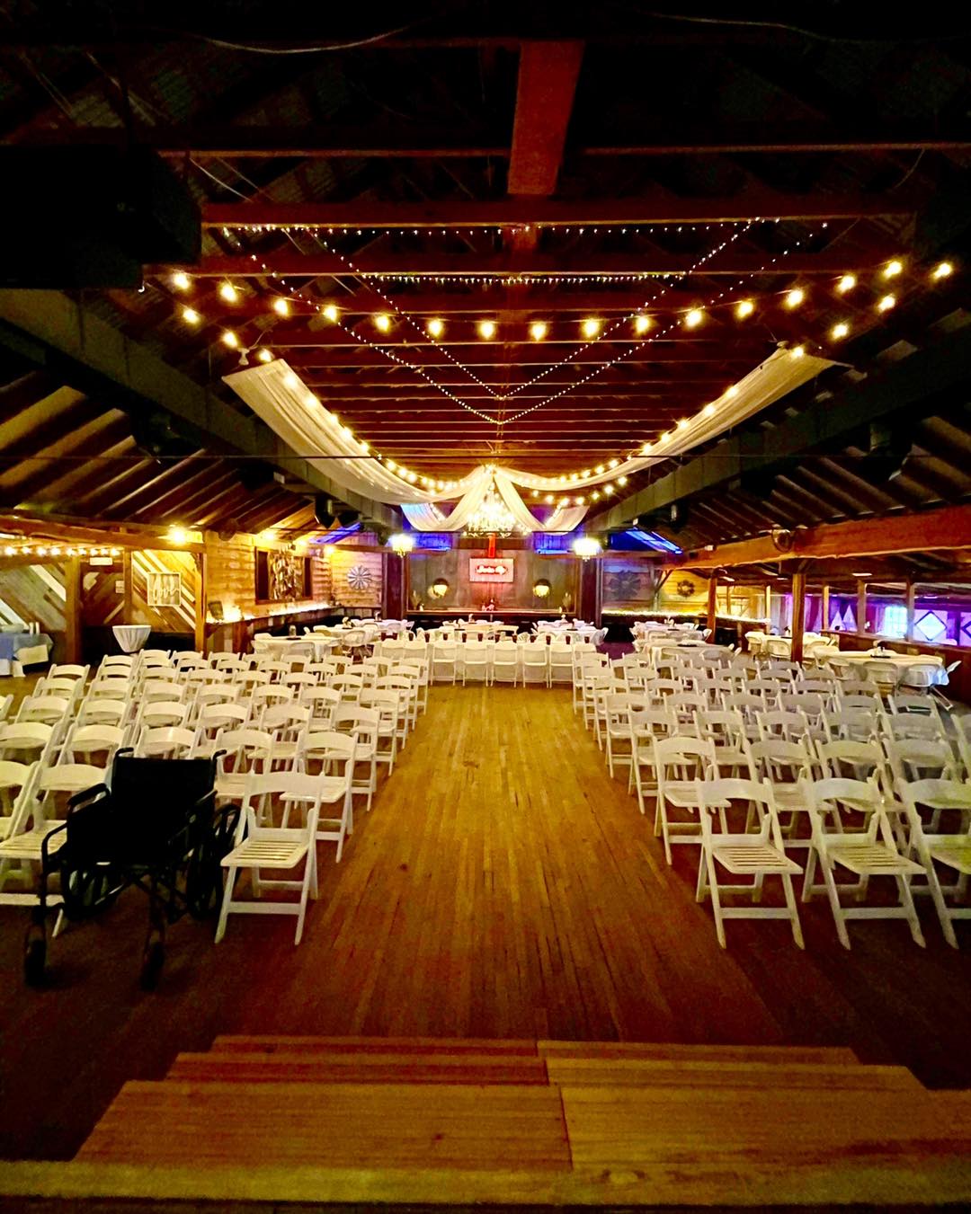 wedding ceremony room lit up by string lights